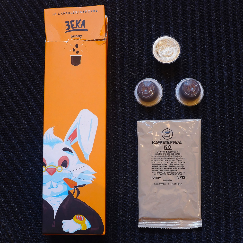 Zeka (Bunny) three coffee capsules with orange packaging box on the dark grey background