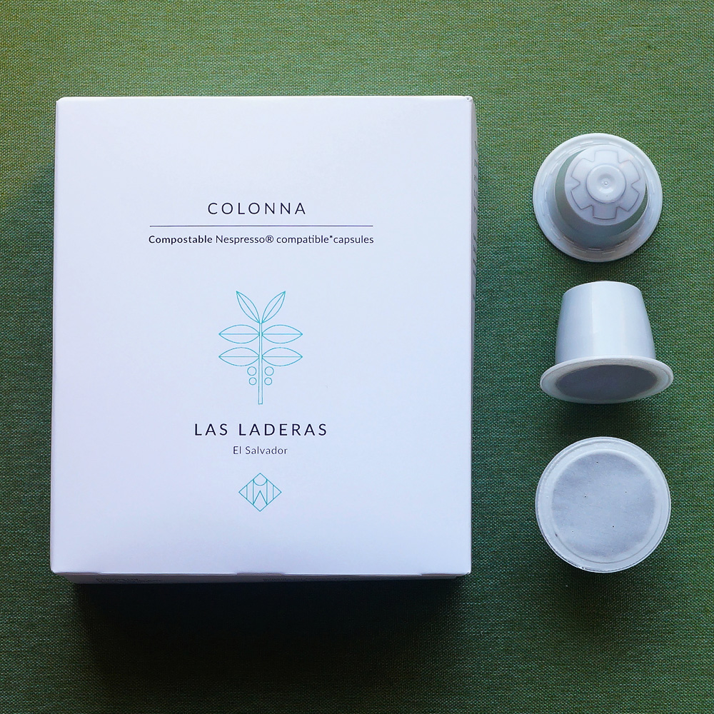 Las Laderas, El Salvador by Colonna - three white coffee capsules and a white box on a green background