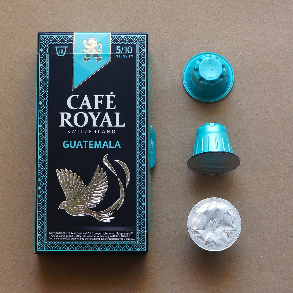 Guatemala by Café Royal - three light blue coffee capsules with a box on beige background