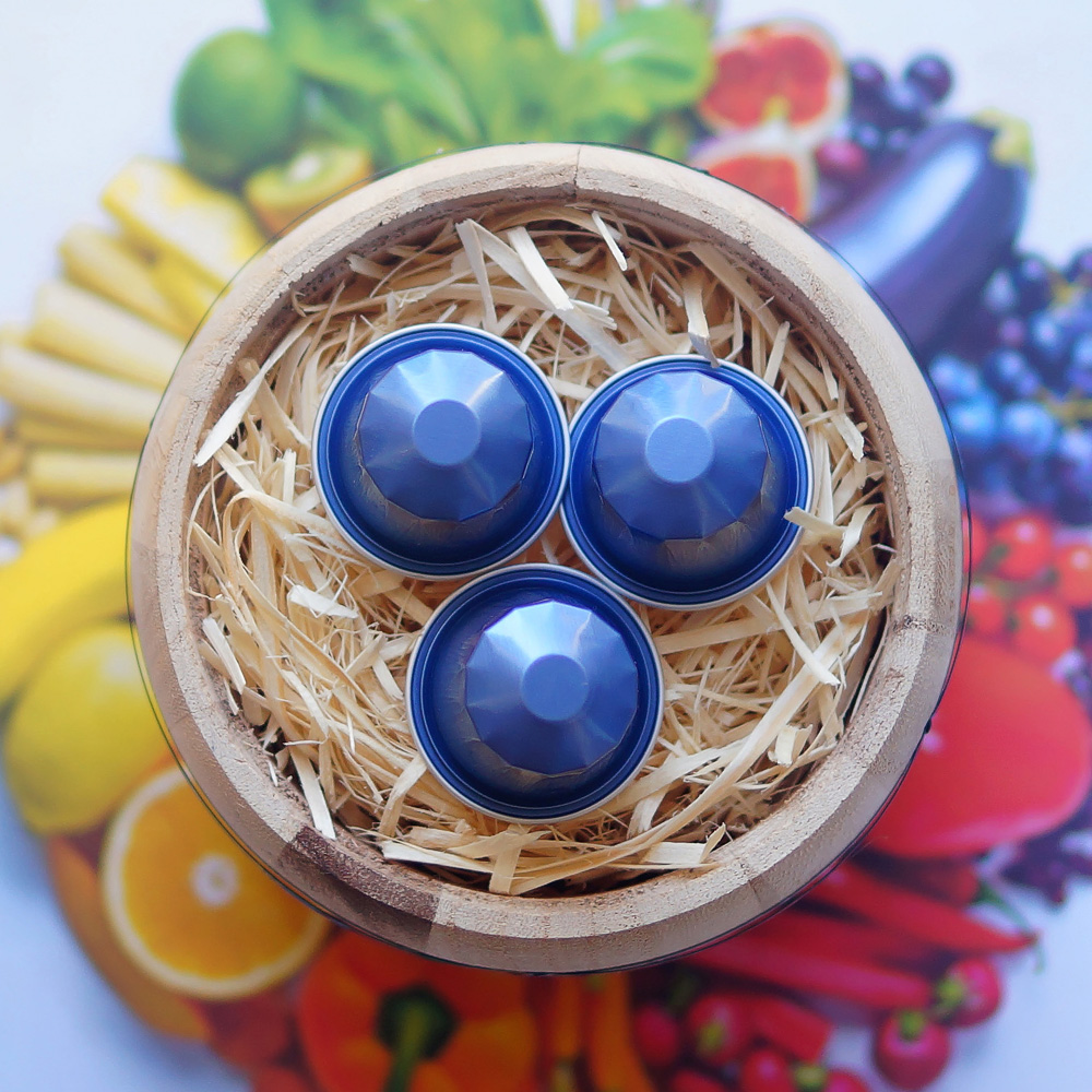 La Granja, Colombia by Colonna - three blue coffee capsules on colourful background