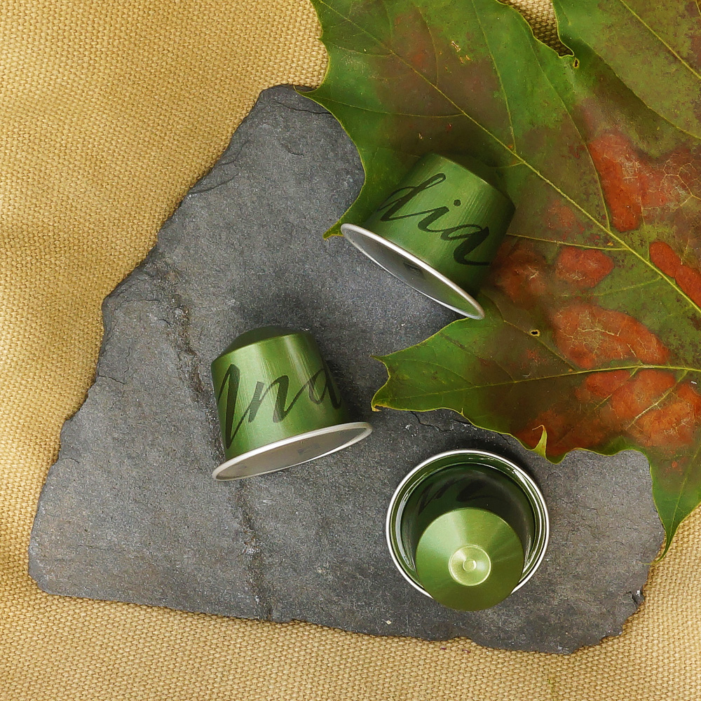 Three green coffee capsules 