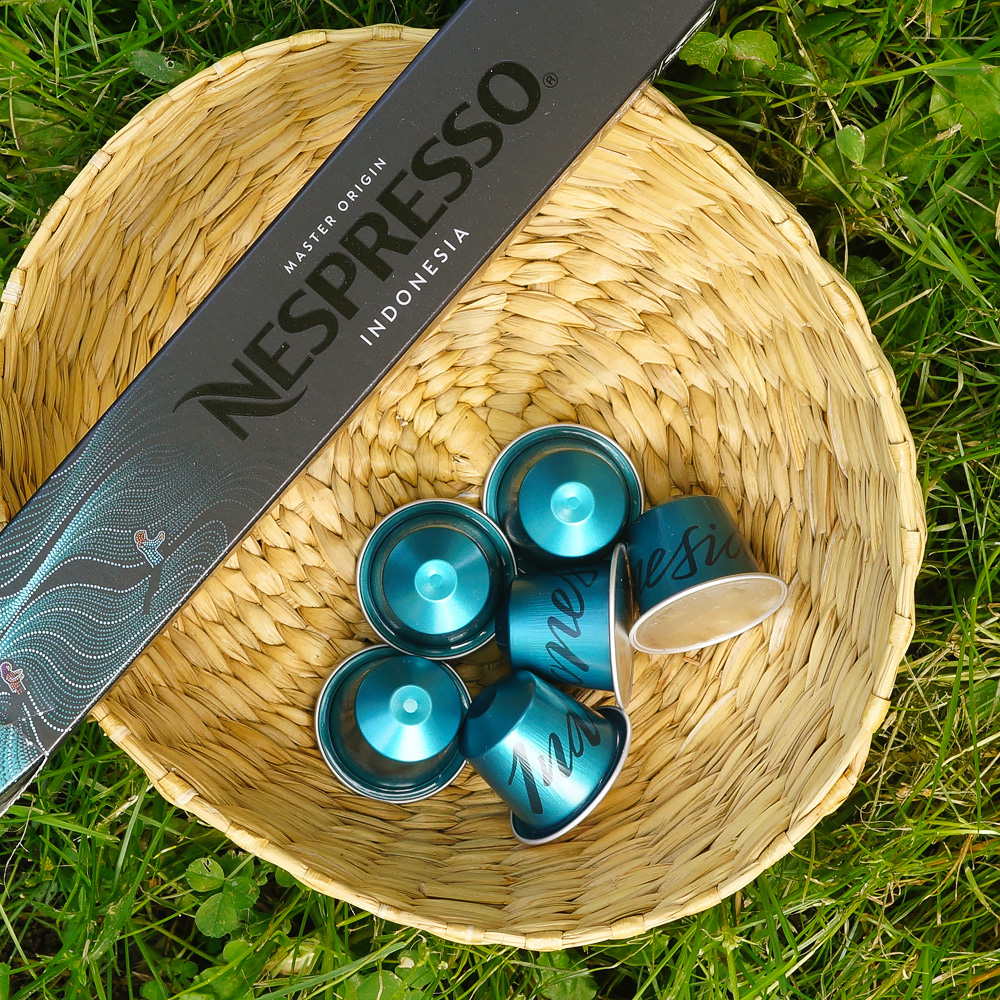 Six brighly blue coffee capsules of Nespresso Indonesia brand and a sleeve box in the basket